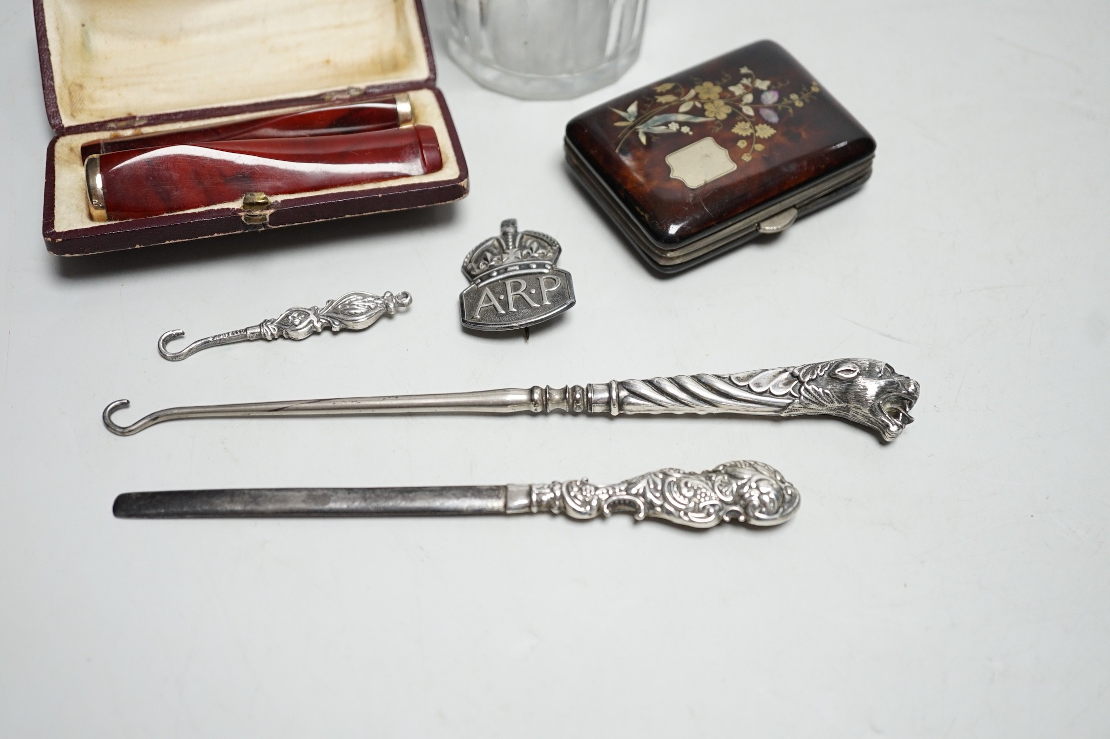 A Georgian silver mounted sugar sifter, a tortoiseshell and plique case, four silver items and two cased cheroot holders